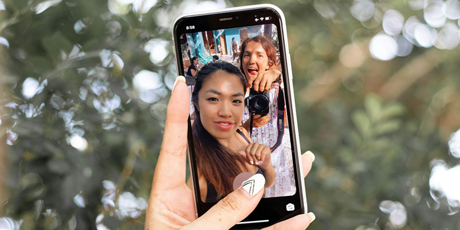 a smartphone with selfie picture of two people